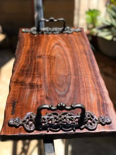 a wooden table with metal handles on it