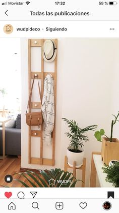 a room with a coat rack and plants on the wall