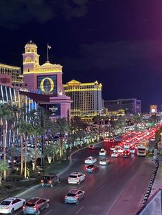 the las vegas strip at night with many cars driving on it and palm trees lining the street