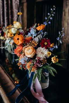 an arrangement of colorful flowers in a vase