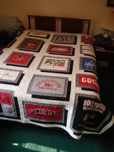 a bed with a quilt made to look like it has many different logos on it