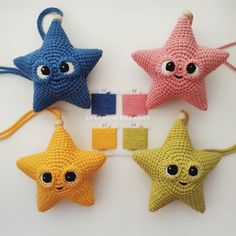 four crocheted star ornaments with eyes on them