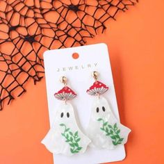 Bring some festive flair to your Halloween celebrations with these adorable dangle drop earrings featuring cute ghost and mushroom designs. The vibrant colors of red, green, and white create a playful contrast, making these earrings a perfect accessory for the spooky season. 

Crafted with care, these whimsical earrings are lightweight and comfortable for all-day wear, making them ideal for Halloween parties, trick-or-treating, or simply enjoying the autumn vibes. Show off your fun and creative Ghost Mushroom, Mushroom Designs, Whimsical Earrings, White Ghost, Colors Of Red, Mushroom Design, Halloween Festival, Halloween Celebration, Autumn Vibes