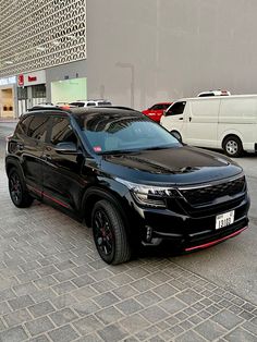 a black suv parked in front of a building