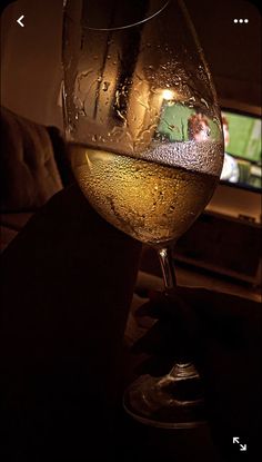 a glass of wine sitting on top of a table