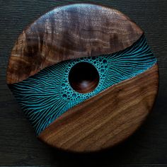 a wooden plate with blue and brown designs on it