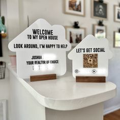 two house shaped signs sitting on top of a counter