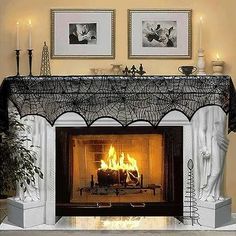 a fire place sitting in the middle of a living room next to two framed pictures