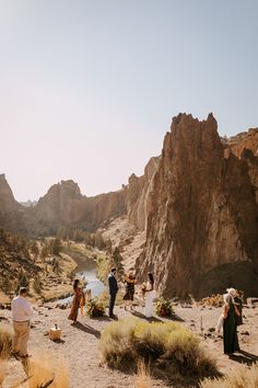 a group of people standing around in the desert