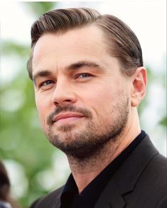 a close up of a person wearing a suit and tie