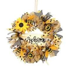 a yellow and black wreath with sunflowers, bees and the word welcome on it