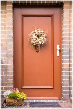 a brown door with a wreath on it