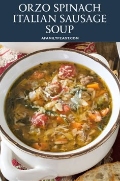 a bowl of orzo spinach and italian sausage soup with bread on the side