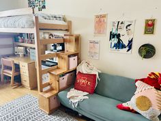 a room with a couch, desk and bunk bed