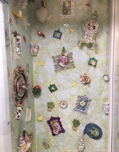 there is a shower that has many pictures on the wall