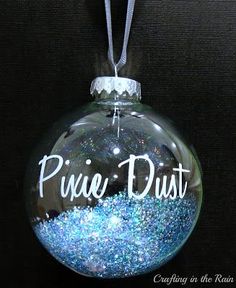 a glass ornament with the word prince dust on it and blue glitter inside