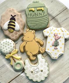 baby shower cookies are arranged in the shape of winnie the pooh and other items