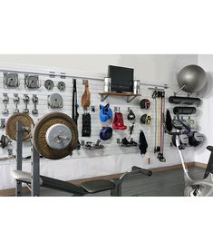 there is a gym room with various equipment on the wall