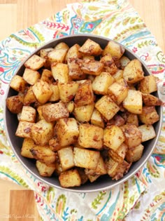 a bowl filled with cooked potatoes on top of a table