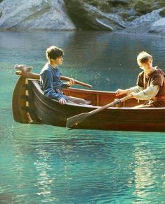 two boys in a boat on the water