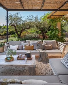 an outdoor living area with couches and tables