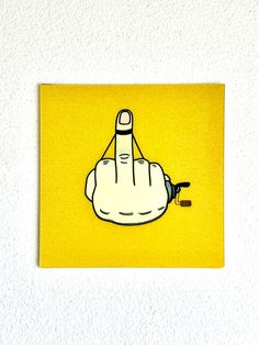 a yellow square with a cartoon hand pointing at something