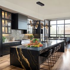 a kitchen with black cabinets and marble counter tops