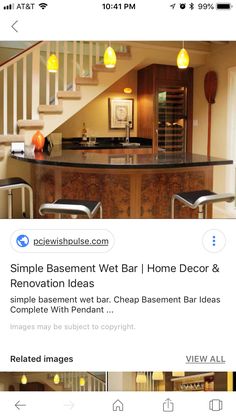 an image of a kitchen with stairs and counter top in the center, below which is a bar