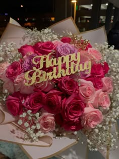 a bouquet of pink roses and baby's breath with the word happy birthday written on it