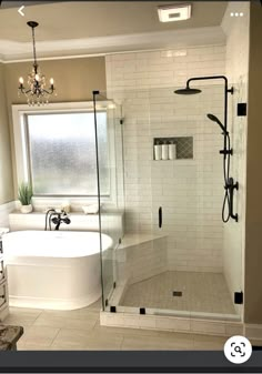 a bathroom with a walk in shower next to a bath tub