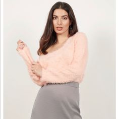 Seriously, You Just Gotta Feel It. Reach For The Out On The Town Blush Fuzzy Sweater This Winter. This Fitted Sweatshirt Features A Scoop Neckline, Tight Sleeves, And A Fuzzy Faux Fur Fabric Throughout. Perfect For Adding A Touch Of Texture To Your Outfits, Pair This Tight Fuzzy Sweater With High Waisted Trousers. Content & Care Nylon Imported Dry Flat Details & Fit Front Length: 27.5"/69.9cm Back Length: 32"/81.3cm Sleeve Length: 25.5"/64.8cm Measured In Size Small Soft/Plush Fabric Pink Long Sleeve Crop Top For Winter, Trendy Pink Sweater For Party, Chic Pink Crop Top For Fall, Casual Pink Sweater For Party, Feminine Pink V-neck Sweater, Trendy Pink Cardigan For Party, Trendy Pink Party Cardigan, Chic Pink Crop Top For Winter, Pink Chic Cardigan For Party