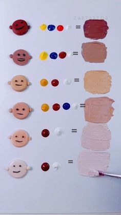 a person holding a paintbrush in front of an art board with different types of paints on it