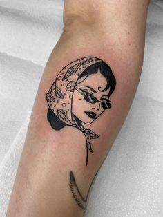 a woman's arm with a black and white tattoo design on the left forearm