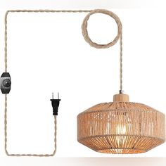 a wicker light hanging from a rope next to an electrical outlet and plugged in