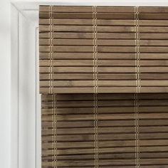 a close up of a window with wooden blinds