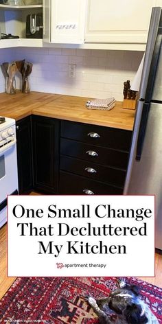 a small kitchen with white cabinets and black counter tops is featured in this postcard