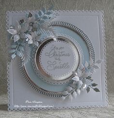 a christmas card with silver and white decorations