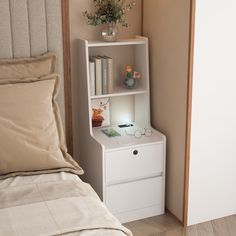 a bed with a book shelf next to it and a lamp on top of the night stand