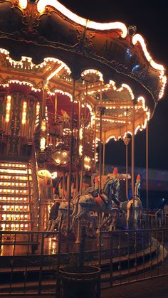 a merry go round at night with people on it