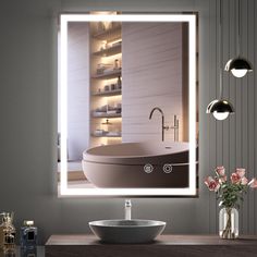 a bathroom with a sink, mirror and bathtub in the reflection on the wall