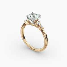 a yellow gold engagement ring with three stones