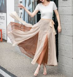 "Introducing our khaki double-layered chiffon wrap skirt. This versatile piece is perfect for adding a touch of elegance to your wardrobe. The lightweight chiffon fabric drapes beautifully, while the double-layered design adds dimension and movement. The wrap style allows for an adjustable fit. Whether you're dressing it up for a special occasion or keeping it casual with a simple top, this skirt is a must-have.  DETAILS: * Chiffon skirt * Chiffon lining * Wrap skirt * with long belt * High wais Chiffon Wrap Skirt, Flowy Long Skirt, Chiffon Midi Skirt, Mod Clothing, Long Chiffon Skirt, Skirt Circle, Long Wrap Skirt, Dresses Vacation, Skirt Chiffon