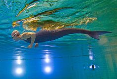 a man swimming under water in a pool