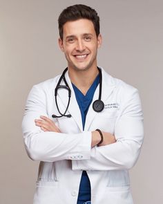 a male doctor in a white coat with his arms crossed