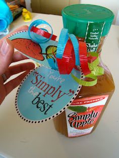 a hand holding up a jar of honey with a label that says simply the best