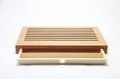 a wooden tray with two drawers on top of each other in front of a white background