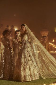 the bride and groom are standing in front of their wedding party, dressed in gold sequins