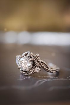 a diamond ring sitting on top of a table