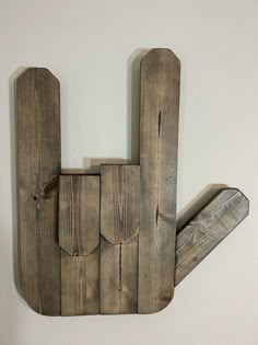 a wooden sign that has been made to look like the letter h on a wall