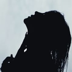 the silhouette of a woman with her mouth open